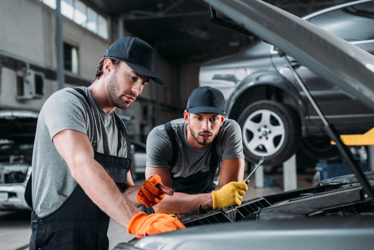 professional-manual-workers-repairing-car-in-mechanic-shop.jpg